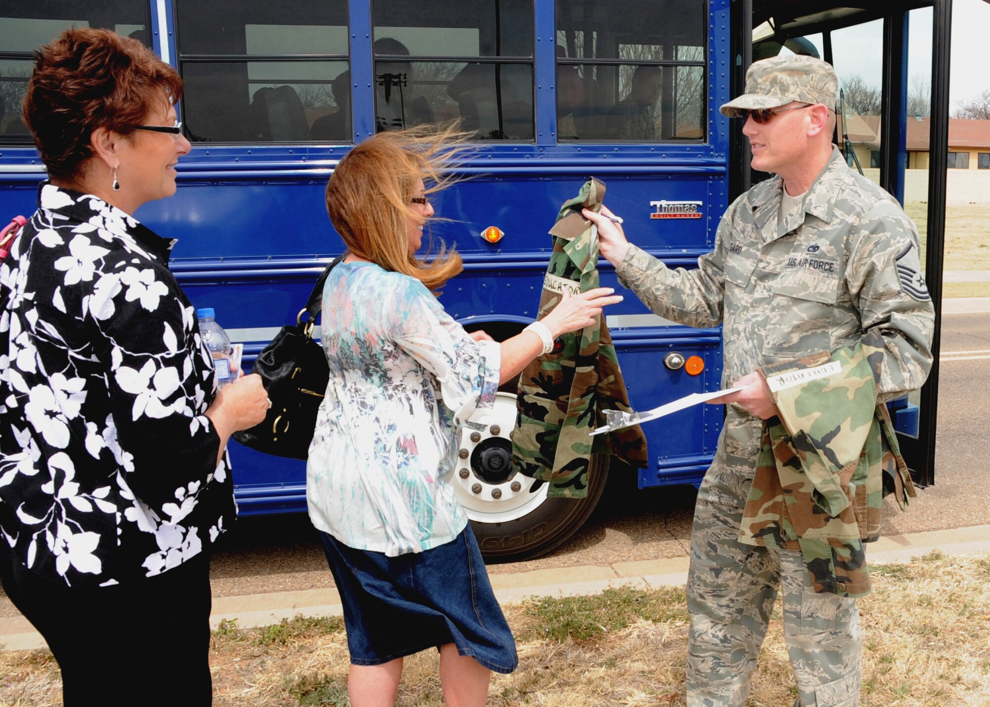 CANNON AIR FORCE BASE, N.M. -- Master Sgt. Tory Gard, 27th Special Operations Force Support Squadron, gave a BDU jacket to Carla Nuttall, a 2nd grade teacher at Mesa Elementary, shortly after arrival April 1.The jackets were issued to add a small touch of realism for the teachers during their participation in the Teachers Understanding Deployed Operations program. (U.S. Air Force photo by Airman 1st Class Maynelinne De La Cruz)