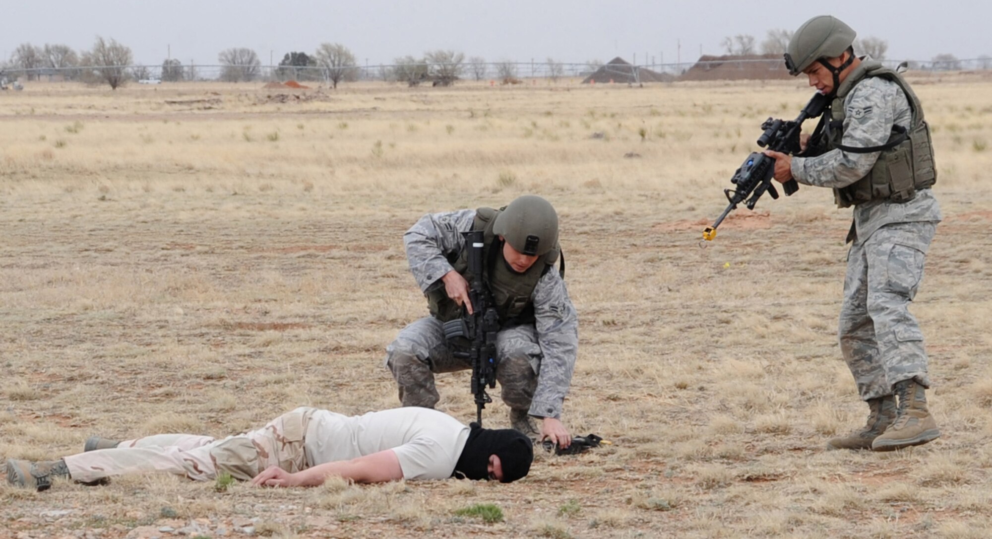 CANNON AIR FORCE BASE, N.M. --Cannon Airmen display techniques used to disarm a terrorist during a simulated training exercise April 1. Local area teachers participated in the Teachers Understanding Deployed Operations program to give them an insight to not only what Airmen encounter while deployed, but the concerns of children while their parents are deployed as well. (U.S. Air Force photo by Airman 1st Class Maynelinne De La Cruz) 