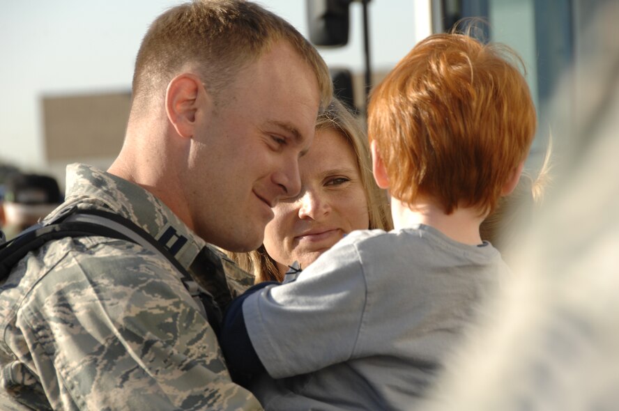 Capt. Robert Effler reunites with his family at the 129th Rescue Wing, Moffett Federal Airfield, Calif., April 6 after a three month deployment to Djibouti. Captain Effler is a combat rescue officer with the 131st Rescue Squadron. (U.S. Air Force photo by Tech. Sgt. Ray Aquino)