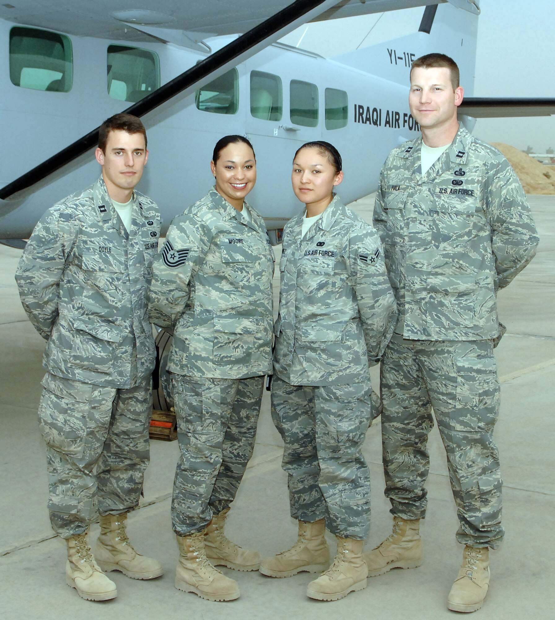 From left, Capt. Peter Doyle, Tech Sgt. Rashida Moore, Senior Airman Angeles Perez, and Capt. Larry Fiala, the administrative staff for the commander of the 506th Air Expeditionary Group at Kirkuk Regional Air Base, Iraq. (U.S. Air Force photo by Master Sgt. Andrew Leonhard)
