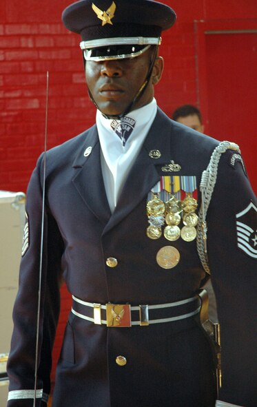 Master Sgt. Steven West, U.S. Air Force Honor Guard Drill Team flight chief, marches in a performance with the U.S. Air Force Honor Guard and the U.S. Air Force Band Max Impact April 1 at Robert E. Lee High School. The U.S. Air Force Honor Guard Drill Team and Max Impact joined forces for the first time to showcase their skills in two joint performances in the Southeast region. (U.S. Air Force photo by Senior Airman R. Michael Longoria)