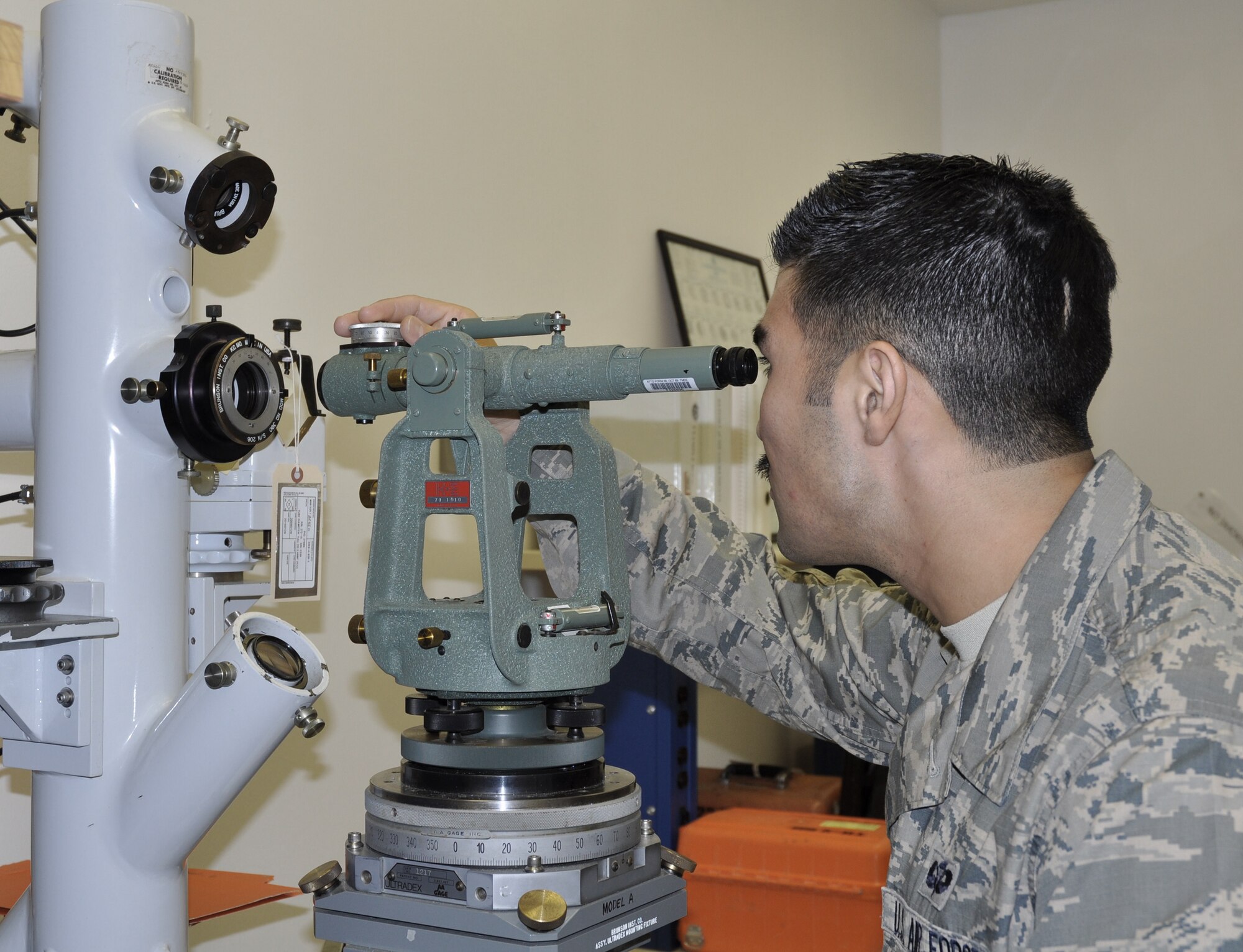 Staff Sgt. Christopher Akin uses a short-range calibrator to ensure survey equipment, telescopes and other optical measuring instruments maintain proper alignment.  Sergeant Akin is a Precision Measurement Equipment Laboratory technician in the 46th Maintenance Squadron at Eglin Air Force Base, Fla.  The Eglin PMEL is responsible for maintaining more than 22,000 pieces of equipment assigned to 406 accounts.  (U.S. Air Force photo/Leslie Brown)