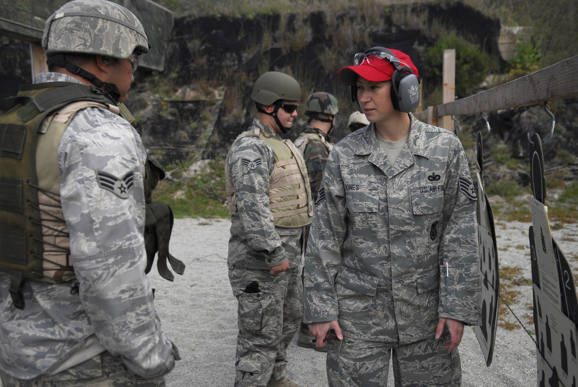 VANDENBERG AIR FORCE BASE, Calif.-- Staff Sgt. Wendy Jones, a 30th Security Forces Squadron combat arms instructor, advises another 30th SFS Airman on firing the M4 Rifle April 2 during training at the firing range here. The 30th SFS Combat Arms Training and Maintenance team trains hundreds of Vandenberg Airmen in a variety of weapons for deployment and recurring qualification.  (U.S. Air Force photo/Senior Airman Christopher Hubenthal)