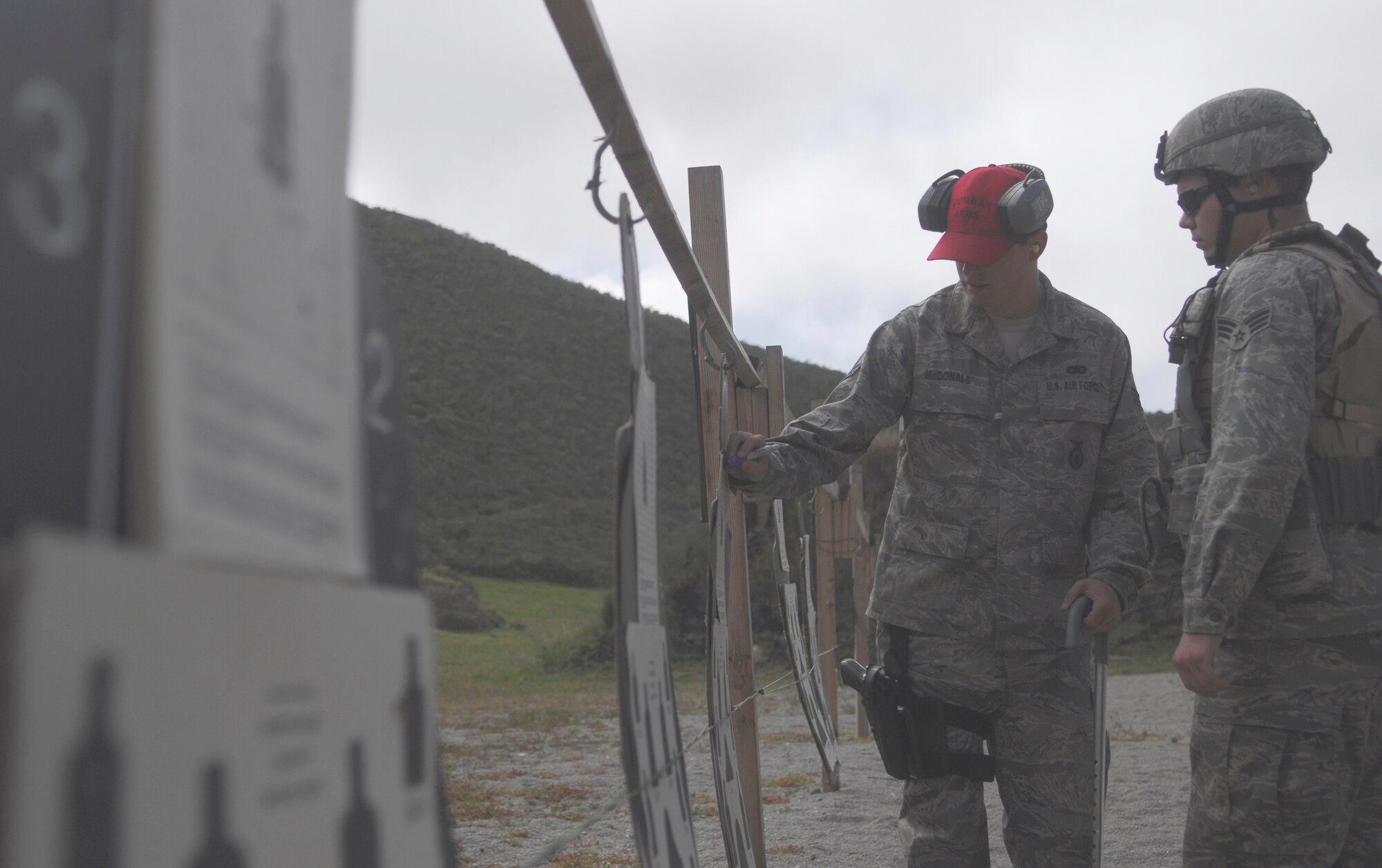 VANDENBERG AIR FORCE BASE, Calif.-- A skilled marksman, Senior Airman Shawn McDonald, a 30th Security Forces Squadron combat arms instructor, advises site correction April 2 during the M4 Rifle training at the firing range here. The 30th SFS Combat Arms Training and Maintenance team trains hundreds of Vandenberg Airmen in a variety of weapons for deployment and recurring qualification.  (U.S. Air Force photo/Senior Airman Christopher Hubenthal)