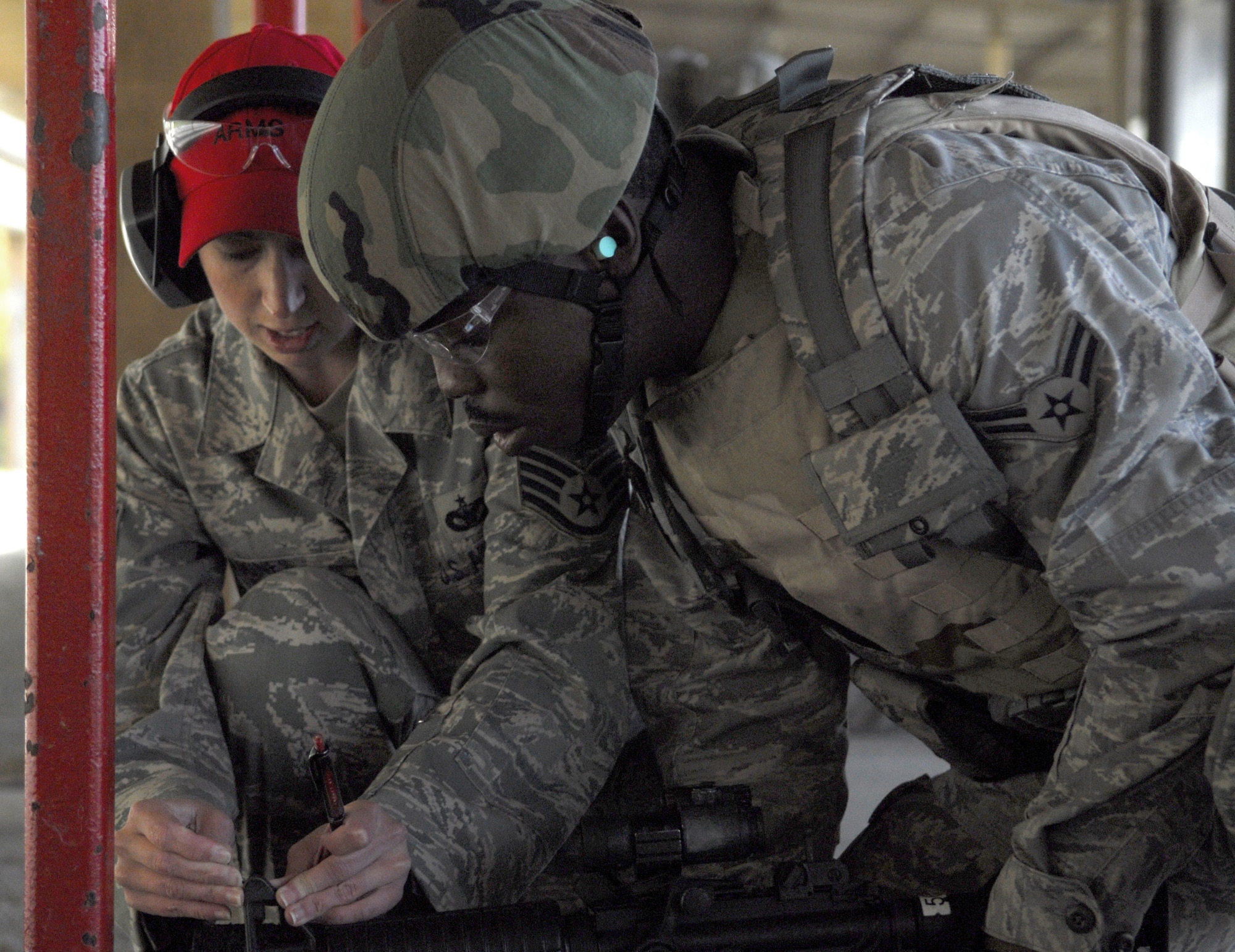 VANDENBERG AIR FORCE BASE, Calif.-- Staff Sgt. Wendy Jones, a 30th Security Forces Squadron combat arms instructor, helps a security forces Airman "zero-in" his M4 Rifle April 2 during training at the firing range here. The 30th SFS Combat Arms Training and Maintenance team trains hundreds of Vandenberg Airmen in a variety of weapons for deployment and recurring qualification.  (U.S. Air Force photo/Senior Airman Christopher Hubenthal)
