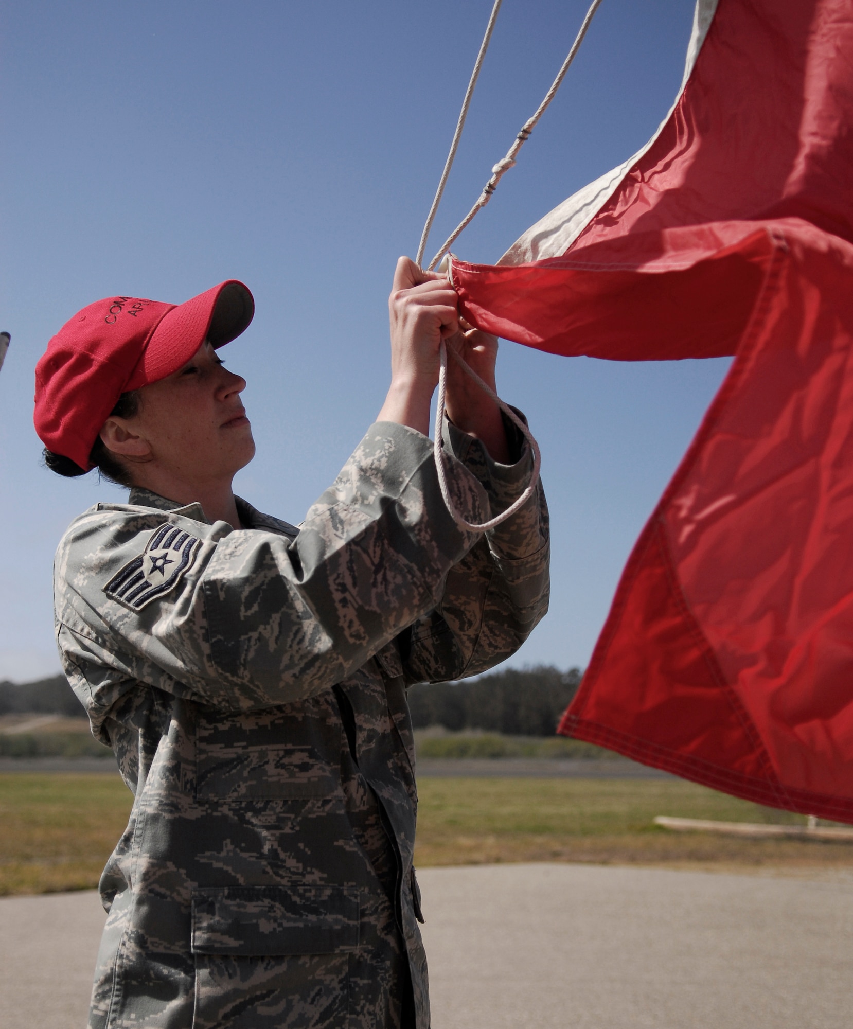 VANDENBERG AIR FORCE BASE, Calif.-- Staff Sgt. Wendy Jones, a 30th Security Forces Squadron combat arms instructor, raises the range flag April 2 prior to M4 Rifle Training at the firing range here. The 30th SFS Combat Arms Training and Maintenance team trains hundreds of Vandenberg Airmen in a variety of weapons for deployment and recurring qualification.  (U.S. Air Force photo/Senior Airman Christopher Hubenthal)