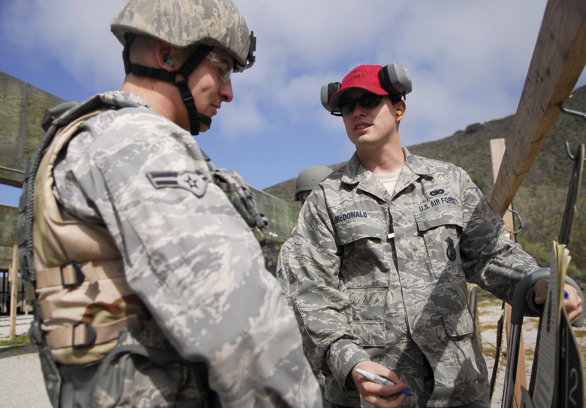 VANDENBERG AIR FORCE BASE, Calif.-- A skilled marksman, Senior Airman Shawn McDonald, a 30th Security Forces Squadron combat arms instructor, advises site correction April 2 during the M4 Rifle training at the firing range here. The 30th SFS Combat Arms Training and Maintenance team trains hundreds of Vandenberg Airmen in a variety of weapons for deployment and recurring qualification.  (U.S. Air Force photo/Senior Airman Christopher Hubenthal)