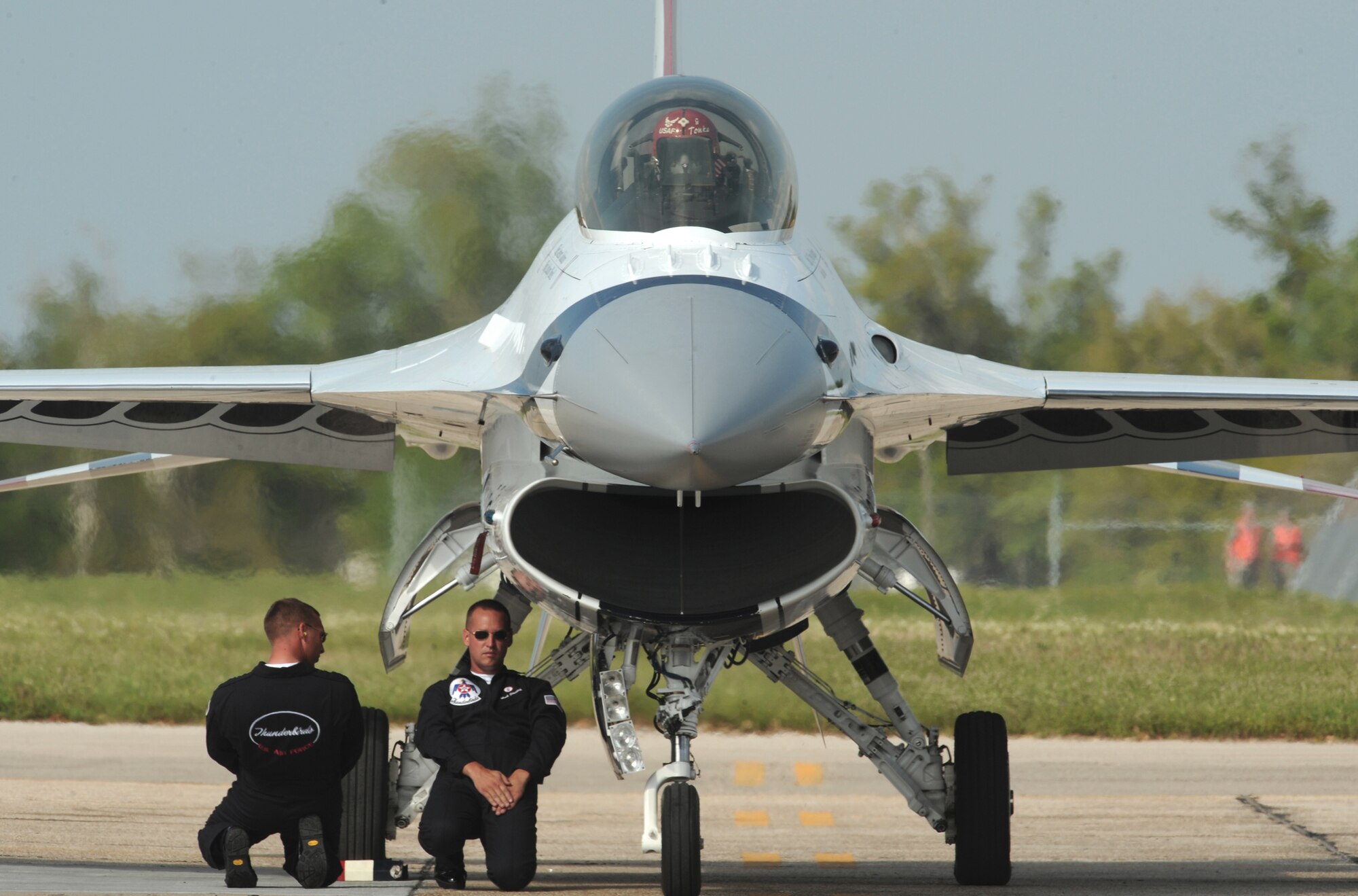 Tech. Sgt. Phil Sawin and Staff Sgt. Mark Stoverink finish their launch procedures prior to Thunderbirds No. 5 taking off April 4 at Keesler Air Force Base, Miss. Sergeants Sawin and Stoverink are crew chiefs for Thunderbirds No. 5. (U.S. Air Force photo/Staff Sgt. Kristi Machado) 
