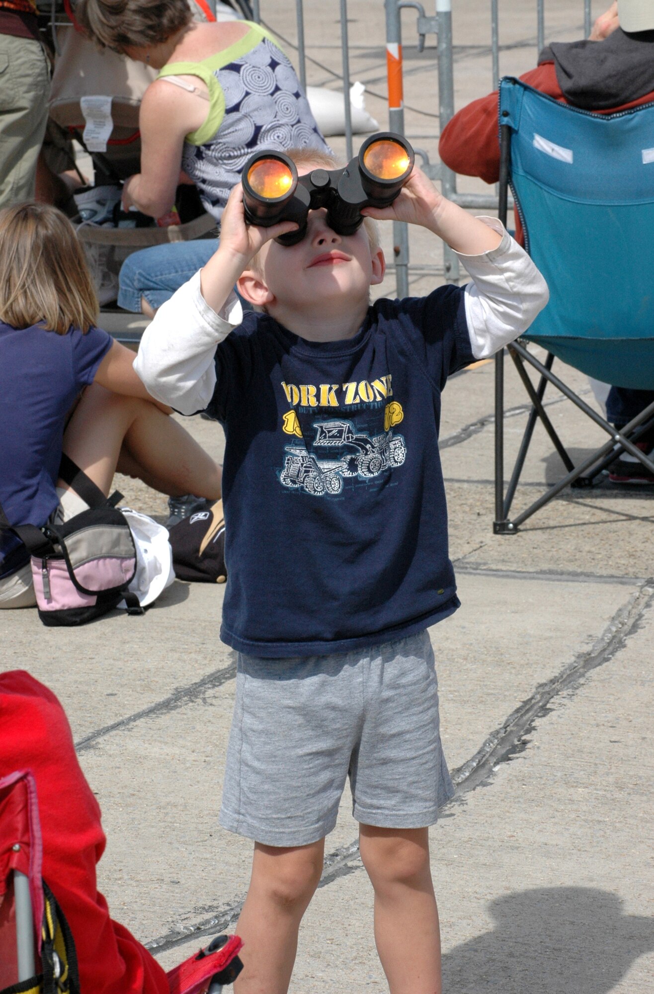 A young spectator scans the skies during the 2009 Keesler Air Force Base "Thunder on the Bay" Air Show and Open House. Several civilian and military groups displayed feats of daring aerial acrobatics during the air show, such as the Army Golden Knights and the Air Force Thunderbirds. 