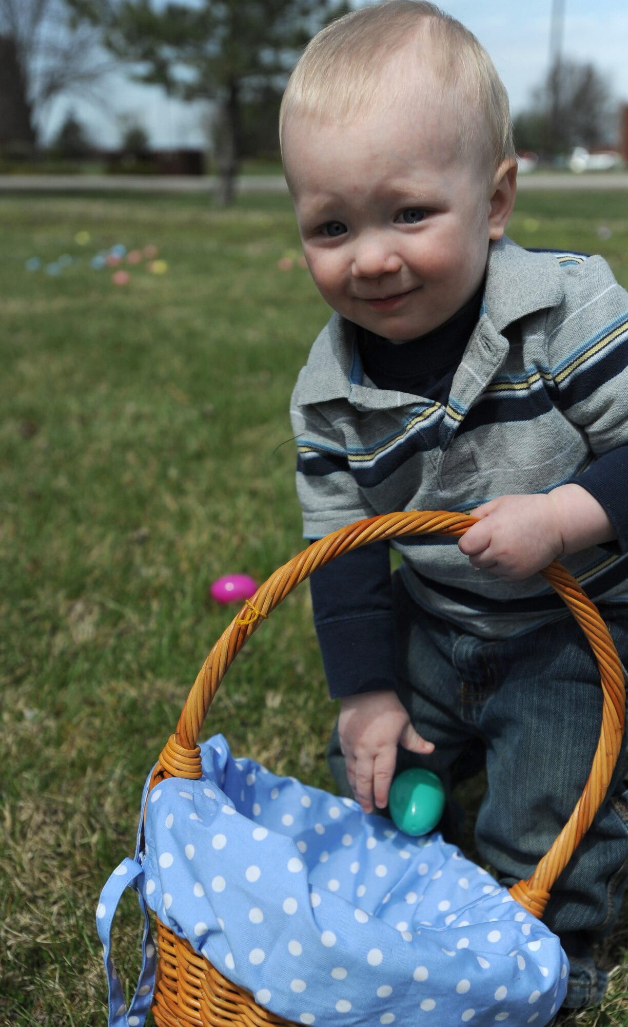 WHITEMAN AIR FORCE BASE, Mo. – Elijah Avery, son of Aaron and Emily Avery, 509th Force Support Squadron, drops an Easter egg into his basket at the Whiteman Community Activity Center’s Easter Egg Hunt April 4. Elijah hunted for more than 1600 eggs hidden around the community center along with other Whiteman children. The Community Center hosts a multitude of events for all ages. (U.S. Air Force Photo/Airman 1st Class Carlin Leslie)