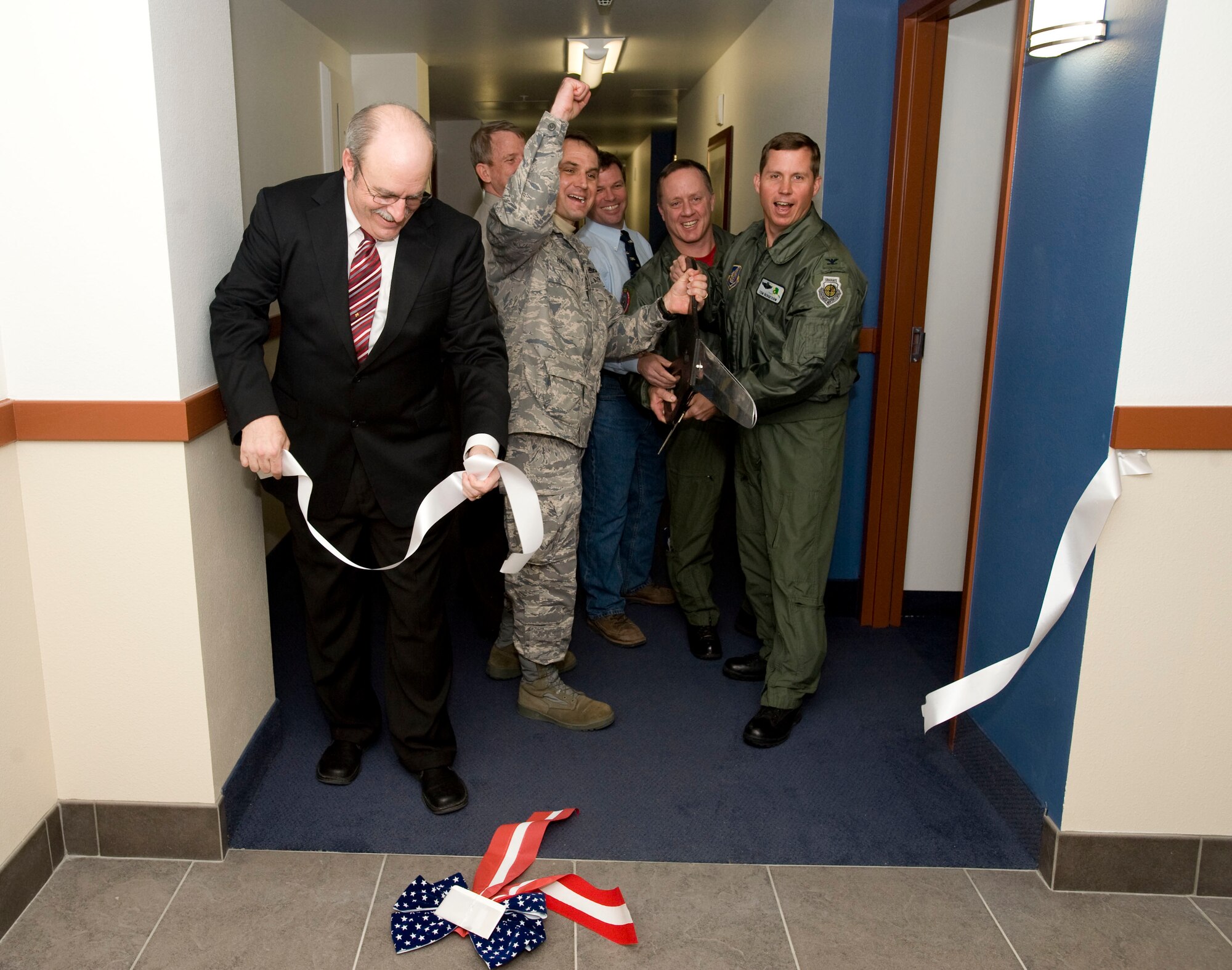 ELMENDORF AIR FORCE BASE, Alaska -- Senior Elmendorf officials, the North Star Inn manager and a CH2M Hill representative cut the ribbon for grand opening of Denali Hall April 3, 2009. The renovated Denali Hall provides 119 additional suites to North Star Inn's available billeting rooms. The renovations took 18 months to complete and cost $22 million. Denali Hall was originally built in 1950s as 500-man dormitory. (U.S. Air Force photo by Senior Airman Jonathan Steffen) 