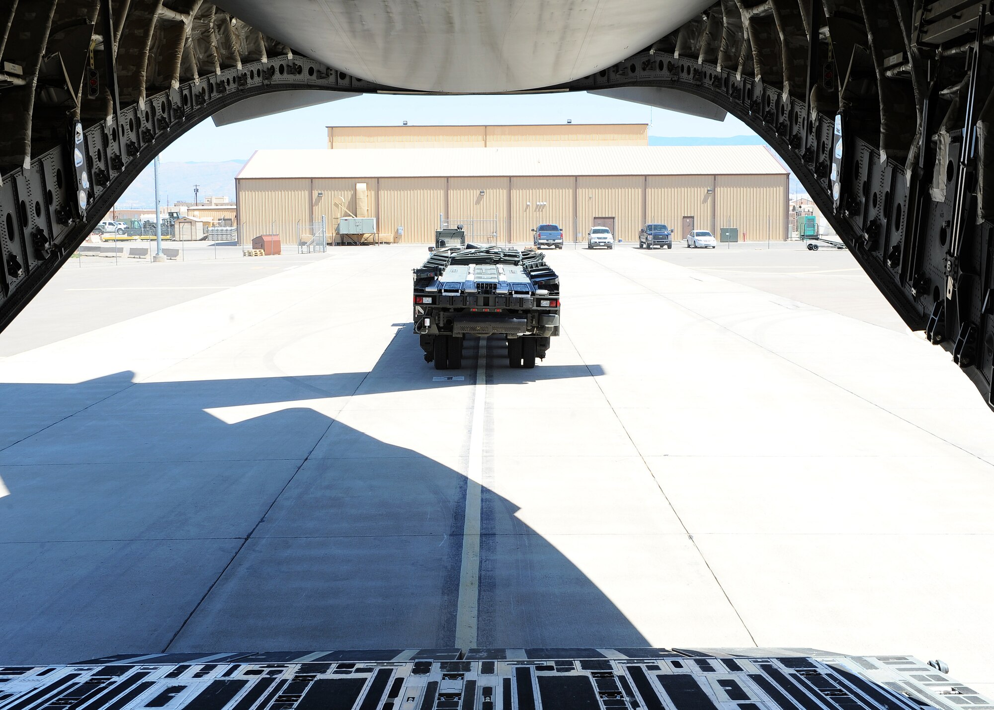 Members of the 49th Logistics Readiness Squadron load a 60,000 pond aircraft loader onto a C-17 from McChord Air Force Base, Wash., here on Holloman Air Force Base, N.M., March 3. The aircraft loader is being deployed to CENTAF to assist with cargo operations in the AOR. (U.S. Air Force photo/ Airman 1st Class DeAndre Curtiss)