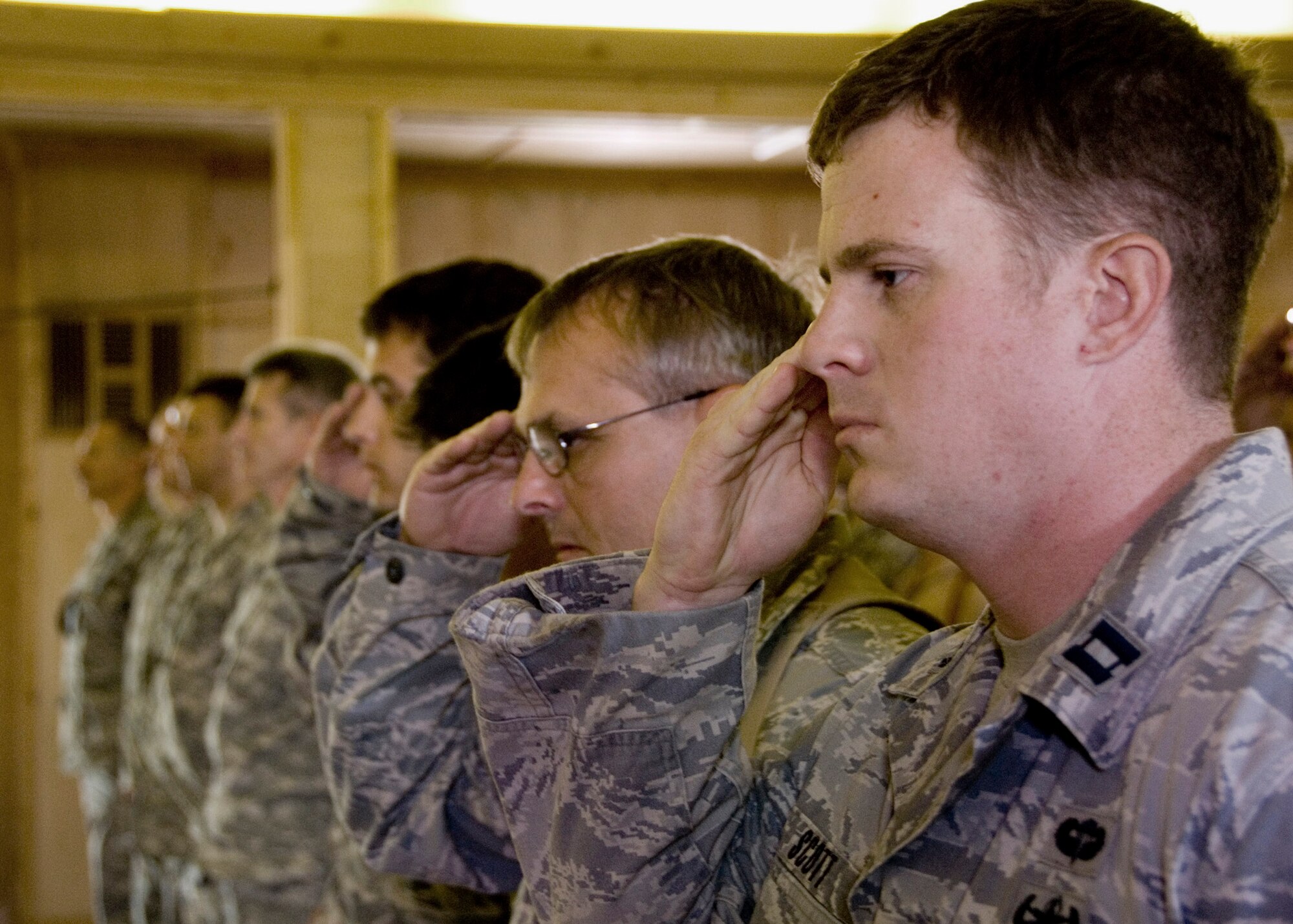 Capt. Robert Scott renders his final salute at the memorial service for fallen explosive ordnance device team leader Staff Sgt. Phillip Myers April 6 at the base chapel at Kandahar Airfield, Afghanistan. Sergeant Myers was killed by an improvised explosive device April 3 during an EOD operation in Musa Qal'eh in the Helmand Province of Southern Afghanistan. Captain Scott is the 755th Air Expeditionary Group Explosive Ordinance Disposal Operational Location Bravo officer in charge. (International Security Assistance Force photo/U.S. Navy Petty Officer 2nd Class Aramis X. Ramirez) 
