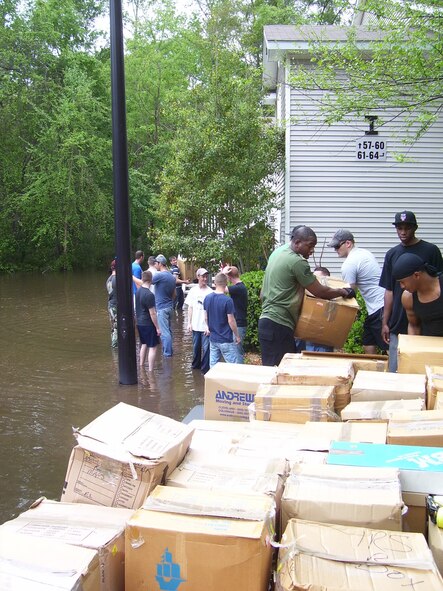 VALDOSTA, Ga. -- Airmen from the 823rd Security Forces Squadron carry boxes filled with belongings of families living at the Links apartment here April 5. Because of flooding, families had to evacuate their apartments. (Courtesy photo)