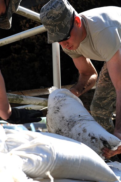 MOODY AIR FORCE BASE, Ga. -- Airman 1st Class Barry Hill, 23rd Civil Engineer Squadron emergency management apprentice, places sand bags around the sewage lift building at the Valdosta Wastewater Treatment Plant to prevent flood damage April 3. Had the pump been flooded, roughly 18,00 local residents could have had sewage backup into their homes.  (U.S. Air Force photo by Airman Joshua Green)


