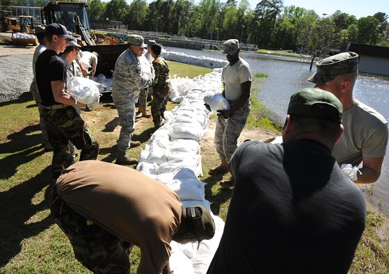 MOODY AIR FORCE BASE, Ga. -- Airmen from the 23rd Civil Engineer Squadron, stack sand bags to prevent flood damage at the Valdosta Wastewater Treatment Plant April 3. Due to flooding caused by heavy rain, the city requested on-site assistance from the 23rd CES to protect a vital lift-pump building. (U.S. Air Force illustration by Airman Joshua Green) 


