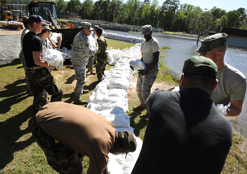 MOODY AIR FORCE BASE, Ga. -- Airmen from the 23rd Civil Engineer Squadron, stack sand bags to prevent flood damage at the Valdosta Wastewater Treatment Plant April 3. Due to flooding caused by heavy rain, the city requested on-site assistance from the 23rd CES to protect a vital lift-pump building. (U.S. Air Force illustration by Airman Joshua Green) 


