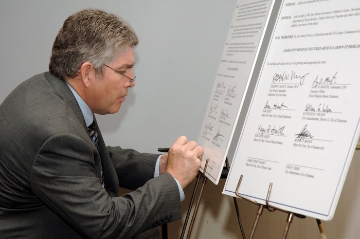 Mayor Pro Tem James Esarey signs a proclamation during the 2nd Annual Joint Community Proclamation Signing ceremony at the Charleston Club April 2. The signing of the proclamation continues collaboration with local communities and military installations for prevention of sexual assault and child abuse. Representatives from six nearby communities, along with the Naval Weapons Station Charleston, joined Charleston AFB in signing the proclamation. Mr. Esarey is the acting mayor representing the city of Goose Creek.  (U.S. Air Force photo/Staff Sgt. Marie Cassetty)
