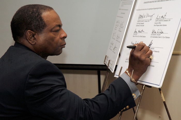 Mayor Pro Tem Aaron Brown signs a proclamation during the 2nd Annual Joint Community Proclamation Signing ceremony at the Charleston Club April 2. The signing of the proclamation continues collaboration with local communities and military installations for prevention of sexual assault and child abuse. Representatives from six nearby communities, along with the Naval Weapons Station Charleston, joined Charleston AFB in signing the proclamation.  Mr. Brown is the acting mayor representing the city of Summerville.  (U.S. Air Force photo/Staff Sgt. Marie Cassetty)