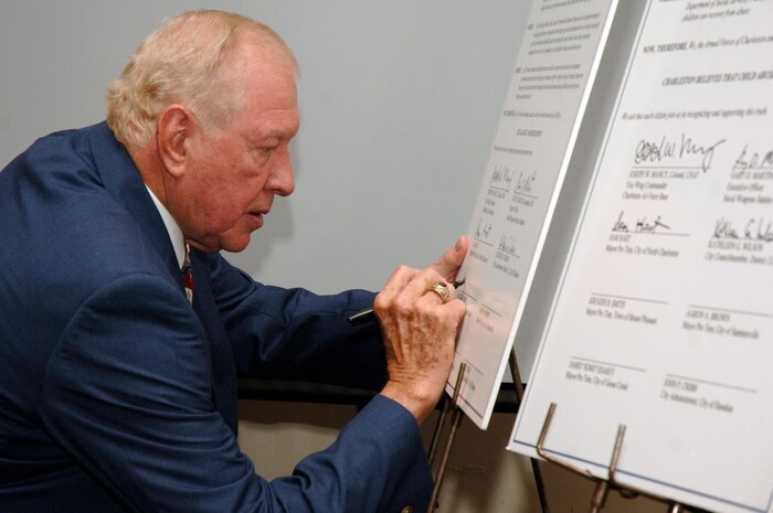 Mayor Pro Tem Kruger Smith signs a proclamation during the 2nd Annual Joint Community Proclamation Signing ceremony at the Charleston Club April 2. The signing of the proclamation continues collaboration with local communities and military installations for prevention of sexual assault and child abuse. Representatives from six nearby communities, along with the Naval Weapons Station Charleston, joined Charleston AFB in signing the proclamation. Mr. Smith is the acting mayor representing the town of Mount Pleasant.  (U.S. Air Force photo/Staff Sgt. Marie Cassetty)