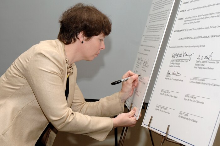 Kathleen Wilson signs a proclamation during the 2nd Annual Joint Community Proclamation Signing ceremony at the Charleston Club April 2. The signing of the proclamation continues collaboration with local communities and military installations for prevention of sexual assault and child abuse. Representatives from six nearby communities, along with the Naval Weapons Station Charleston, joined Charleston AFB in signing the proclamation.  Mrs. Wilson is city of Charleston, District 12 councilmember.  (U.S. Air Force photo/Staff Sgt. Marie Cassetty)