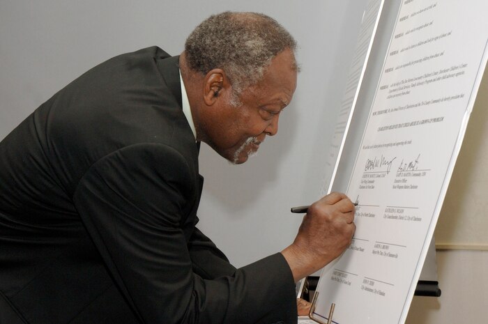 Mayor Pro Tem Sam Hart signs the proclamation during the 2nd Annual Joint Community Proclamation Signing ceremony at the Charleston Club April 2. The signing of the proclamation continues collaboration with local communities and military installations for prevention of sexual assault and child abuse. Representatives from six nearby communities, along with the Naval Weapons Station Charleston, joined Charleston AFB in signing the proclamation.  Mr. Hart is the acting mayor representing the City of North Charleston.  (U.S. Air Force photo/Staff Sgt. Marie Cassetty)