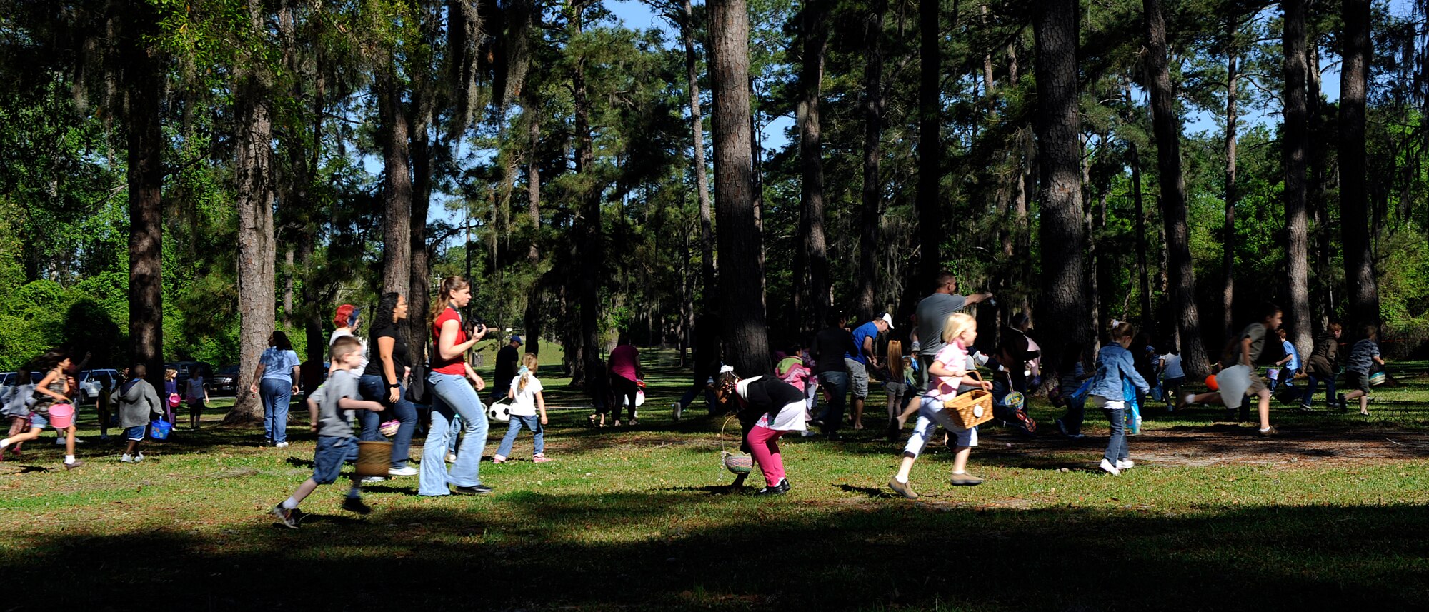 MOODY AIR FORCE BASE, Ga. -- Children participating in an Easter egg hunt run through a field looking for eggs and treats here April 4. Children searched for plastic eggs stuffed with treats and prizes. (U.S. Air Force photo by Senior Airman Brittany Barker)