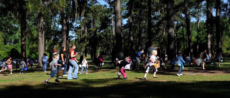 MOODY AIR FORCE BASE, Ga. -- Children participating in an Easter egg hunt run through a field looking for eggs and treats here April 4. Children searched for plastic eggs stuffed with treats and prizes. (U.S. Air Force photo by Senior Airman Brittany Barker)