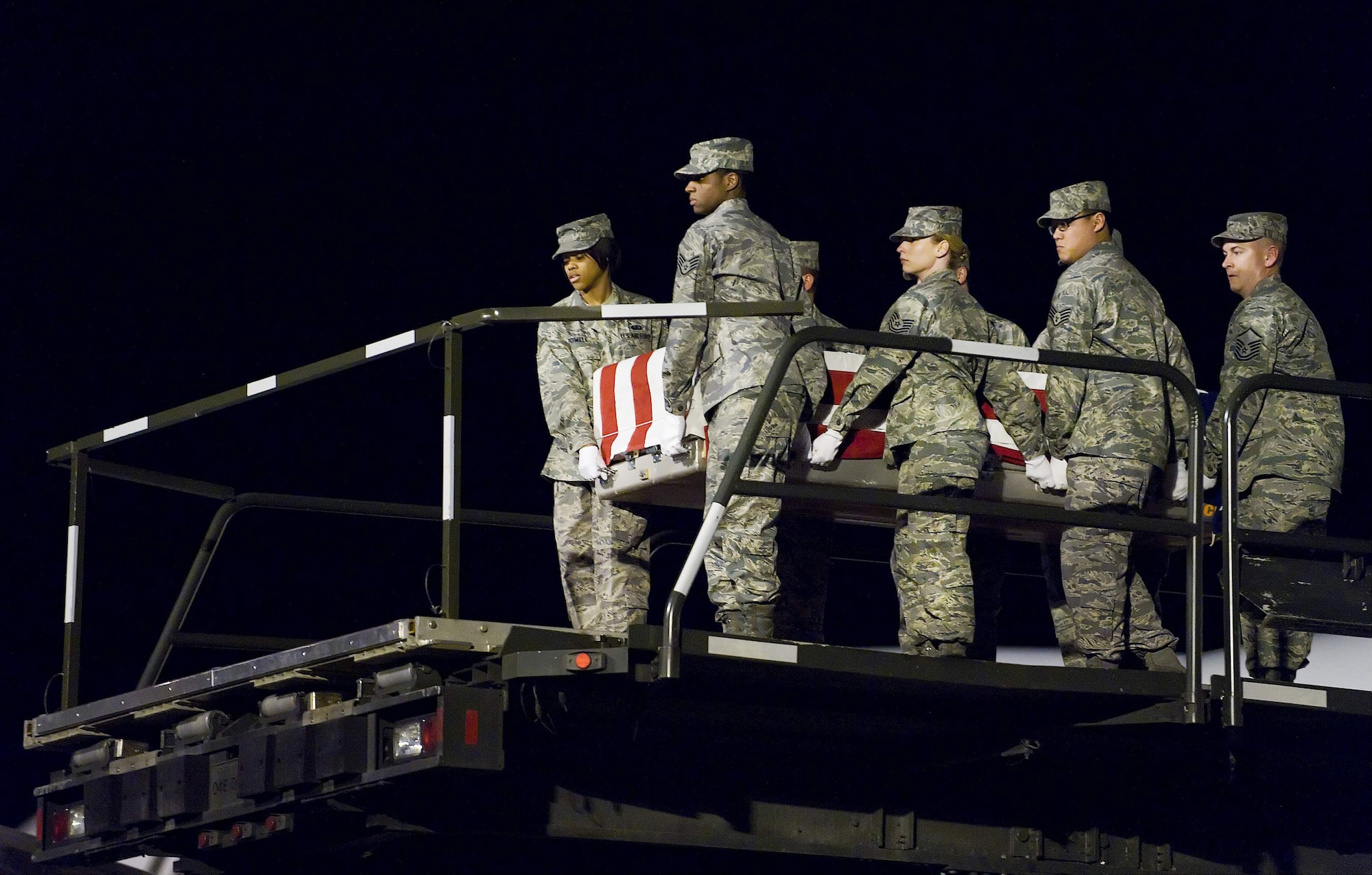 An Air Force Mortuary Affairs Operations Center carry team transfers the remains of Air Force Staff Sgt. Phillip A. Myers, of Hopewell, Va., from an aircraft at Dover Air Force Base, Del., April 5. Sergeant Myers died April 4 near Helmand Province, Afghanistan, from wounds suffered from an improvised explosive device. He was assigned to the 48th Civil Engineer Squadron, Royal Air Force Lakenheath, United Kingdom. Sergeant Myers' family is the first to allow media to cover the dignified transfer under the new Department of Defense policy. (U.S. Air Force photo/Roland Balik)