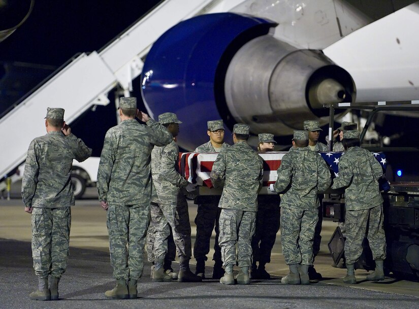 An Air Force Mortuary Affairs Operations Center carry team transfers the remains of Air Force Staff Sgt. Phillip A. Myers, of Hopewell, Va., from the aircraft at Dover Air Force Base, Del., April 5. Sergeant Myers died April 4 near Helmand Province, Afghanistan, from wounds suffered from an improvised explosive device. He was assigned to the 48th Civil Engineer Squadron, Royal Air Force Lakenheath, United Kingdom. Sergeant Myers' family is the first to allow media to cover the dignified transfer under the new Department of Defense policy. (U.S. Air Force photo/Roland Balik)