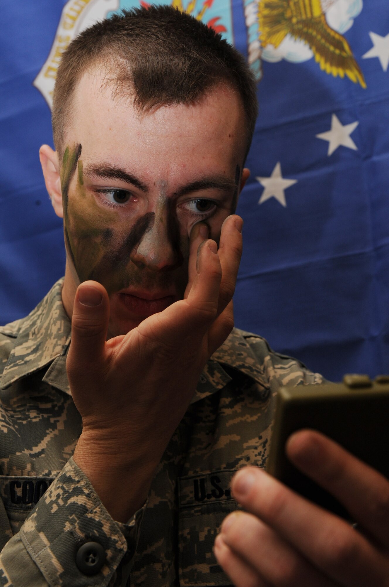 Airman 1st Class Charles Cooksey, 28th Munitions Squadron munitions systems operator, demonstrates the use of camouflage paint during the Cultural Expo 2009 in Rapid City, S.D., March 28. During the event Ellsworth Airmen demonstrated how to use equipment needed to accomplish the Air Force mission. (U.S. Air Force photo/Airman 1st Class Joshua J. Seybert)