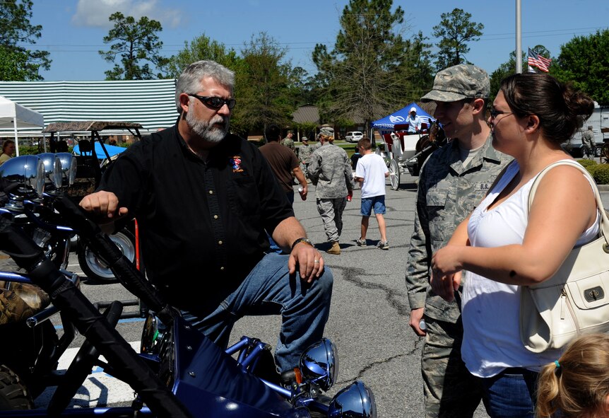 MOODY AIR FORCE BASE, Ga. – Senior Airman Robert Sisco, 38th Rescue Squadron radio shop, and his wife Amy talk with Jeff Godwin, owner of American V-twin Motorcycle Company, about a Sand Viper Dunn Buggy at the Outdoor Extravaganza here April 3. Mr. Godwin represented one of the many downtown vendors who came to the event to showcase what services they offer. (U.S. Air Force photo by Senior Airman Gina Chiaverotti)