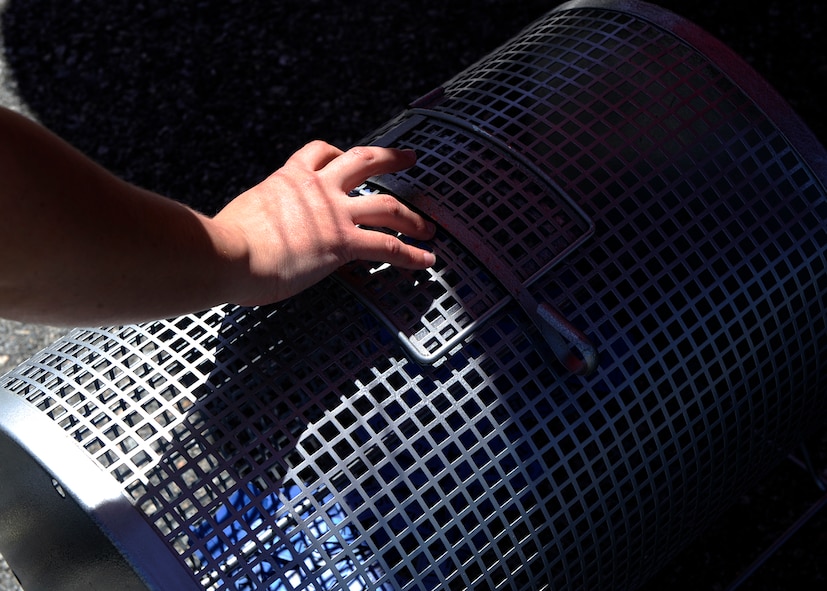 MOODY AIR FORCE BASE, Ga. -- Mischel Wheeler, 23rd Force Support Squadron outdoor adventure manager, reaches to draw the winning ticket during a raffle at the annual Outdoor Extravaganza here April 3. Outdoor Extravaganza is held annually to inform Moody personnel of the outdoor recreational activities offered on base and in the local community. (U.S. Air Force photo by Senior Airman Brittany Barker)