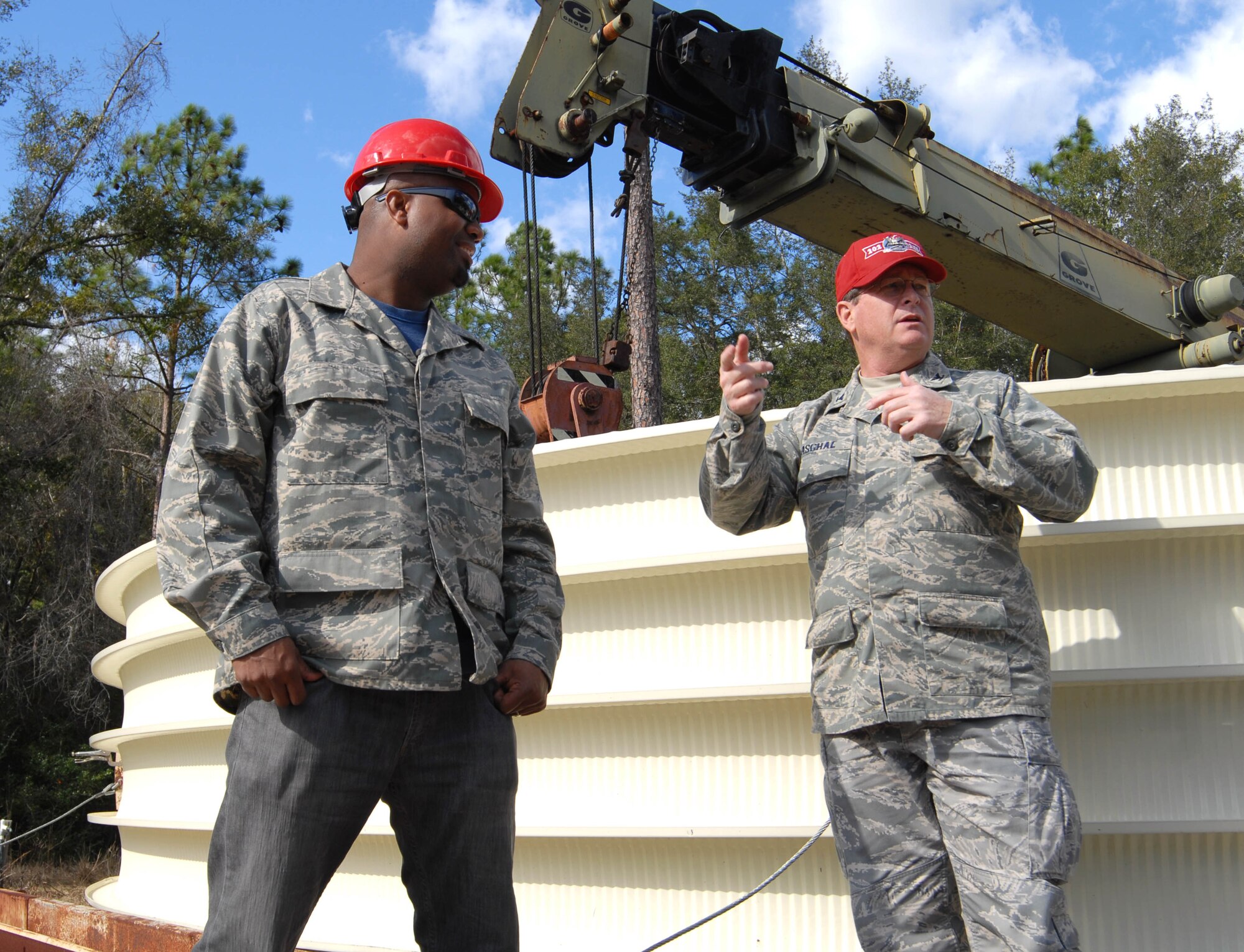 Commander of the 202nd REDHORSE squadron Col. Jack Paschal (right) talks with "Cool Tools" host Chris Grundy during filming at Camp Blanding Joint Training Center, Jan. 8, 2009.