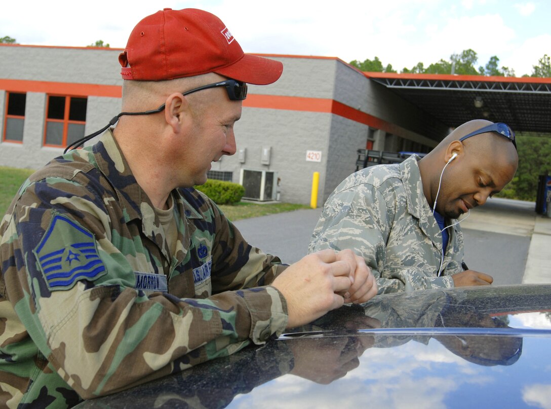 "Cool Tools" host Chris Grundy (right) signs an autograph for Master Sgt. Alden Morrow during filming at Camp Blanding Joint Training Center, Jan. 8, 2009.  