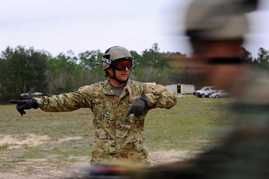 HURLBURT FIELD, Fla. -- An instructor directs students from the 720th Special Tactics Training Squadron to enter a smaller inner circle as they speed by during a beginner level dirt bike course here, March 31. By redirecting the flow of bikes, the instructors test the student's ability to keep their eyes forward and ready for any sudden change in direction. (U.S. Air Force photo/ Senior Airman Julianne Showalter)(RELEASED)