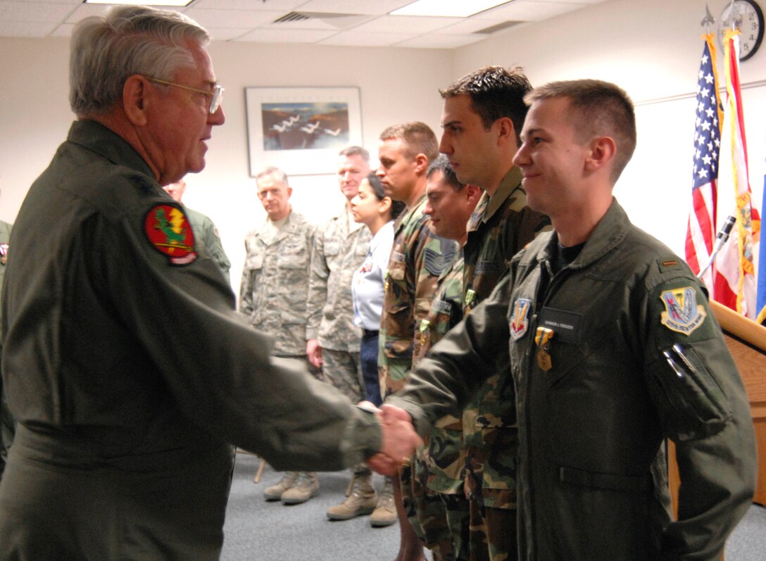 The Adjutant General of Florida Maj. Gen. Douglas Burnett (left) congratulates 2nd Lt. Brannon Ferguson of the Det. 1, 125th Fighter Wing, after presenting him with the Air Force Commendation Medal at the Homestead Air Reserve Base, Feb. 6, 2009.  The Adjutant General was at the base presenting awards and congratulating the unit on success during a recent inspection.