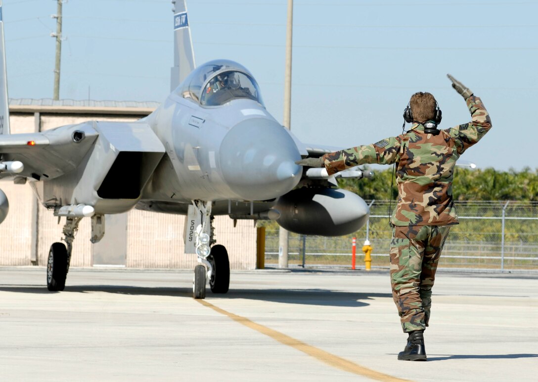 Tech. Sgt. Aaron Hartley of the Florida Air National Guard's Det. 1, 125th Fighter Wing, guides an F-15 Eagle on the flightline at Homestead Air Reserve Base, Fla., Feb. 5, 2009.