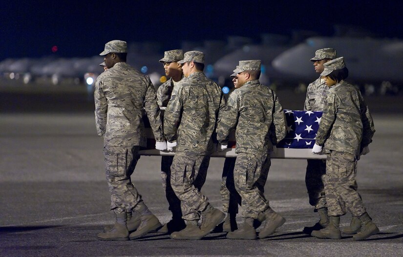 An Air Force Mortuary Affairs Operations Center carry team transfers the remains of Air Force Staff Sgt. Phillip A. Myers, of Hopewell, Va., at Dover Air Force Base, Del., April 5. Sergeant Myers died April 4 near Helmand Province, Afghanistan from wounds suffered from an improvised explosive device. He was assigned to the 48th Civil Engineer Squadron, Royal Air Force Lakenheath, United Kingdom. Sergeant Myers' family is the first to allow media to cover the dignified transfer under the new Department of Defense policy. (U.S. Air Force photo/Roland Balik)  
