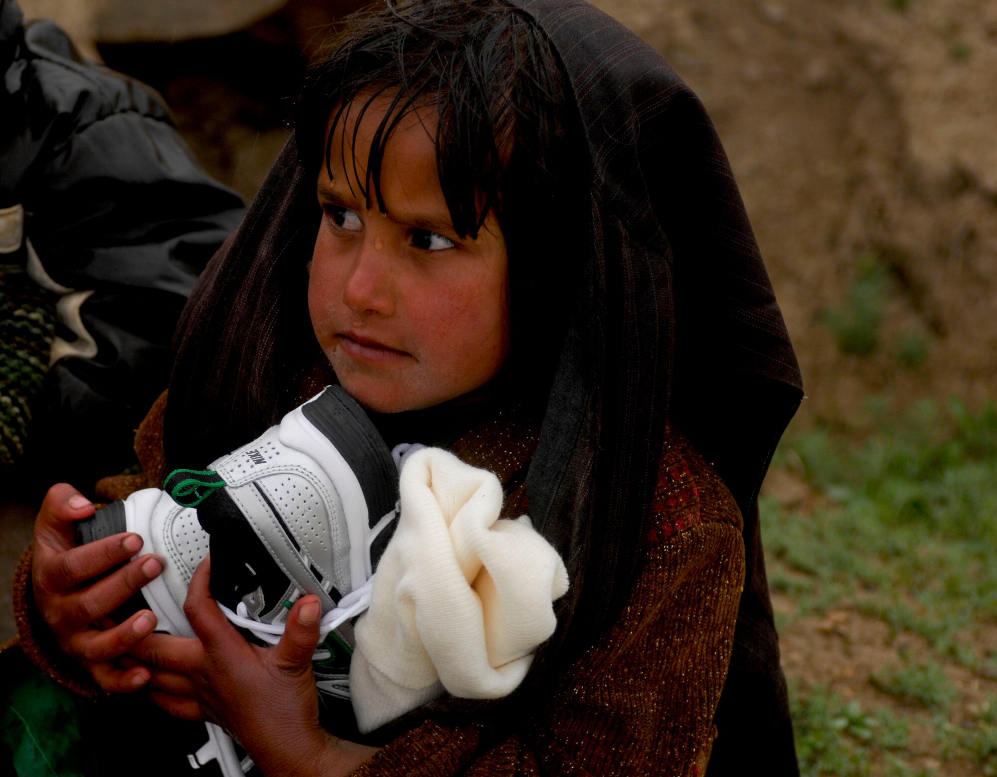 A child in a local village near Bagram Air Field, Afghanistan, received
clothing and shoes from Air Force personnel  April 1. The team handed out
humanitarian goods to approximately 20 children. (U.S. Air Force photo/
Senior Airman Erik Cardenas)(Released) 
