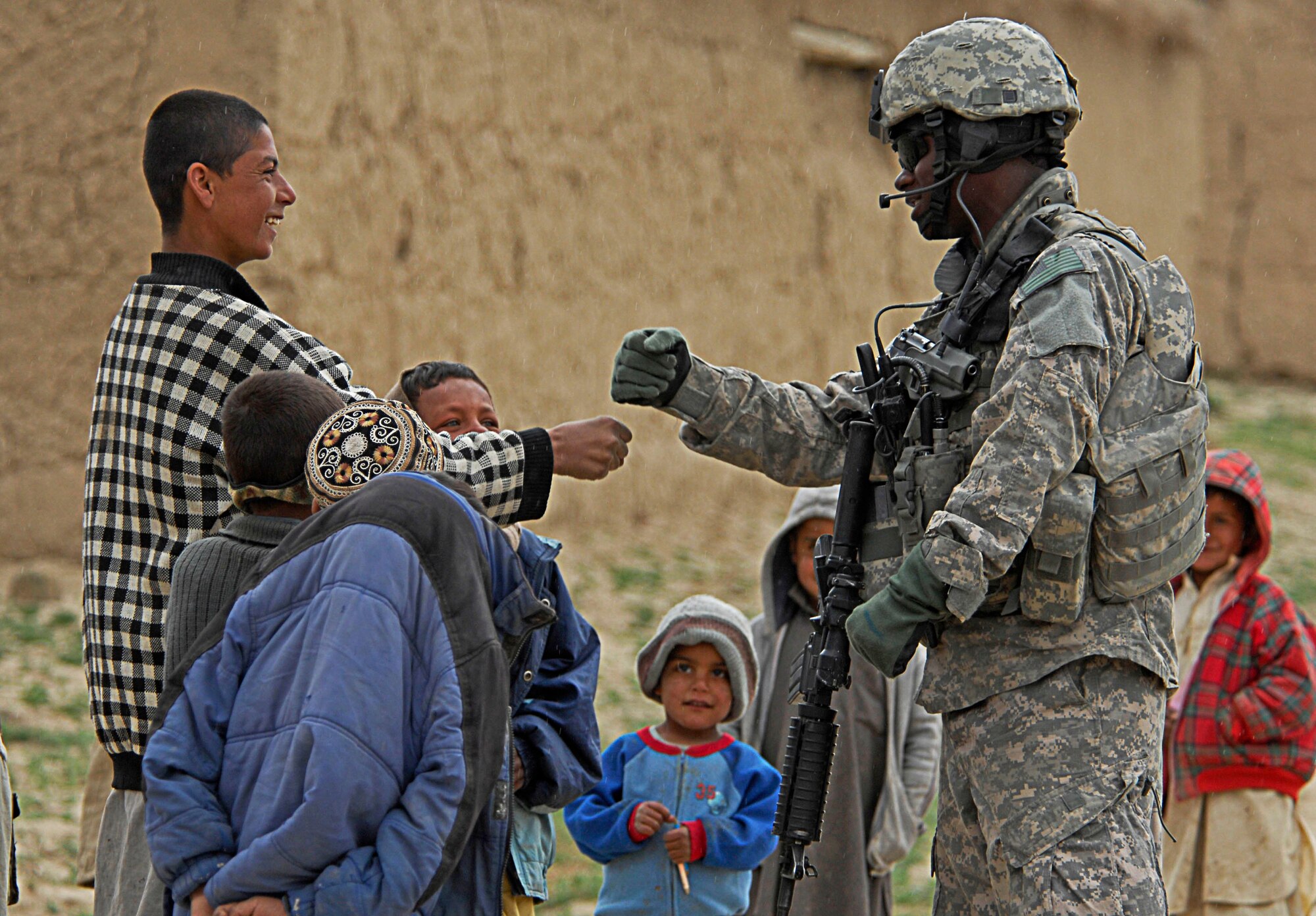 A senior airman interacts with local children while members of the unit
handed out humanitarian goods to a local village near Bagram Air Field,
Afghanistan, April 1. The humanitarian goods contained, clothes, blankets,
shoes and toys. The Airman is deployed from Shaw Air Force Base, S.C. (U.S.
Air Force photo/ Senior Airman Erik Cardenas)(Released) 
