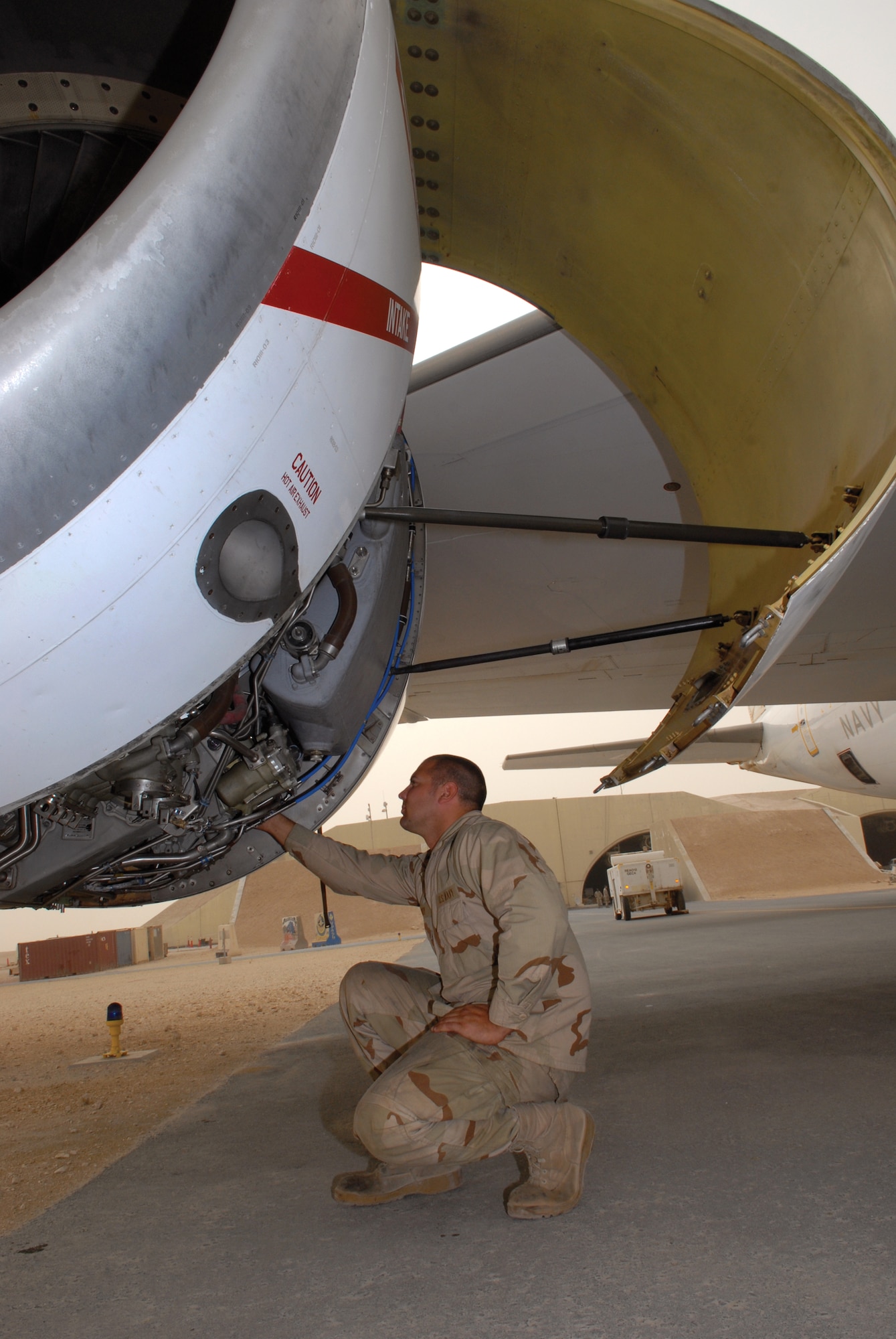 Petty Officer 3rd Class Zach Burghy, TF-124 aviation machinist, checks the oil level of one of the E-6B Mercury jet engine after a mission, April 1, 2009, at an undisclosed location in Southwest Asia. Petty Officer Burghy hails from Livingston, Wis. and is deployed from Tinker Air Force Base, Okla., in support of Operations Iraqi and Enduring Freedom and Combined Joint Task Force - Horn of Africa. (U.S. Air Force photo by Senior Airman Andrew Satran/Released)