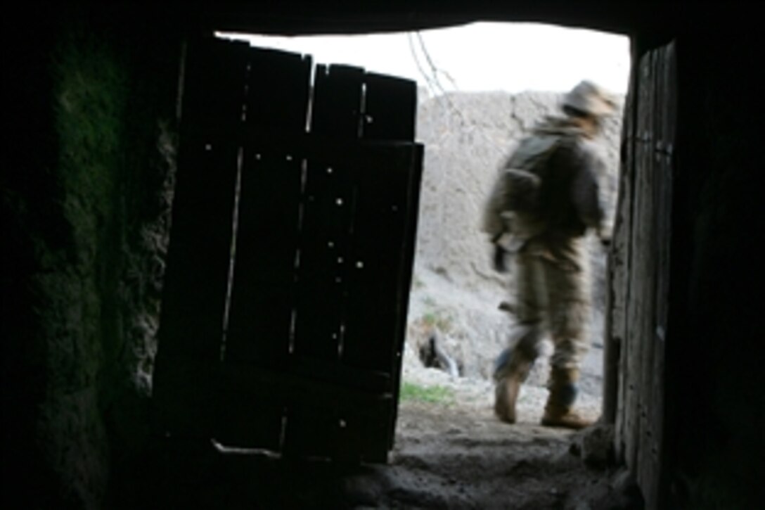 U.S. Marine Corps Cpl. Donovan Saffo exits a building during an operation in the abandoned village of Now Zad in Helmand province, Afghanistan, April 3, 2009. Saffo is a team leader assigned to Lima Company, 3rd Battalion, 8th Marine Regiment. 
