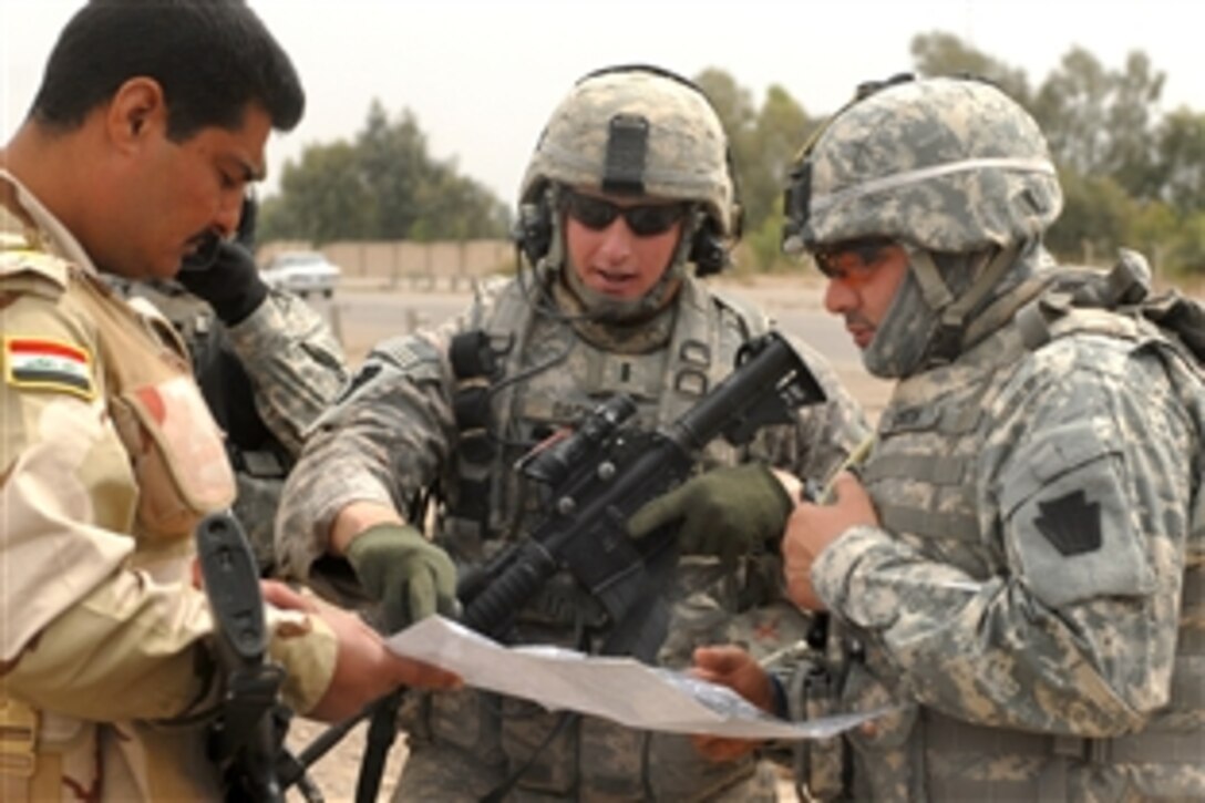 U.S Army 1st Lt. Andrew Dacey reviews security check points with the Iraqi army in Abu Ghraib, Iraq, March 31, 2009. Dacey is assigned to the 1st Infantry Division's 2nd Brigade.