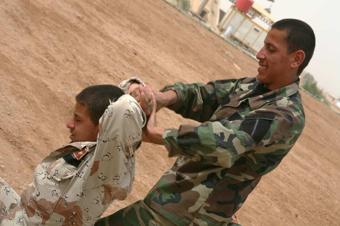 Iraqi commandos with the 7th Iraqi Army Division practice detainee handling during a course instruction taught by Reconnaissance Marines with 2nd Platoon, Bravo Company, 1st Reconnaissance Battalion, Regimental Combat Team 8, April 7, 2009 at Al Asad Air Base, Iraq. Marines with 1st Recon have been training Iraqi commandos with the 7th Iraqi Army Division on fundamental infantry tactics during a month-long training evolution.