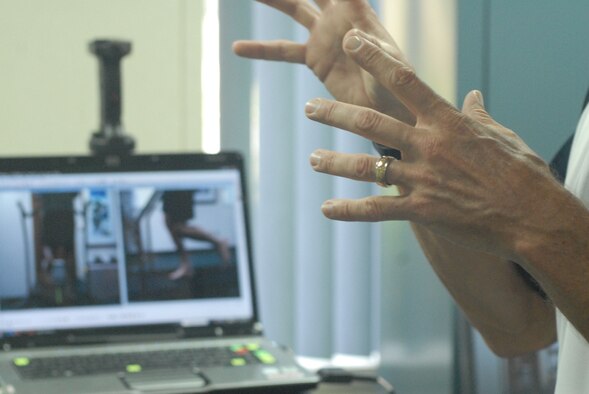 Bryan Hafler, an Human Performance and Rehabilitation Center fitness specialist and Iron Man, explains the results of Staff Sgt. Angel Villalobos's gait analysis at Hickam Air Force Base, Hawaii April 7. In addition to the gait analysis testing, the HPARC offers body fat assessments and one-one-one training including diet and workout plans. (U.S. Air Force photo/Tech. Sgt Cohen Young) 