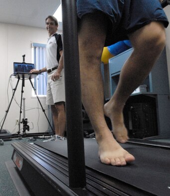 Bryan Hafler, a fitness specialist at the Human Performance and Rehabilitation Center at Hickam Air Force Base, Hawaii, analyzes Staff Sgt. Angel Villalobos's gait April 7. The HPARC offers gait analysis to any TriCare beneficiaries with a referral from their primary care manager. (U.S. Air Force photo/Tech. Sgt Cohen Young) 