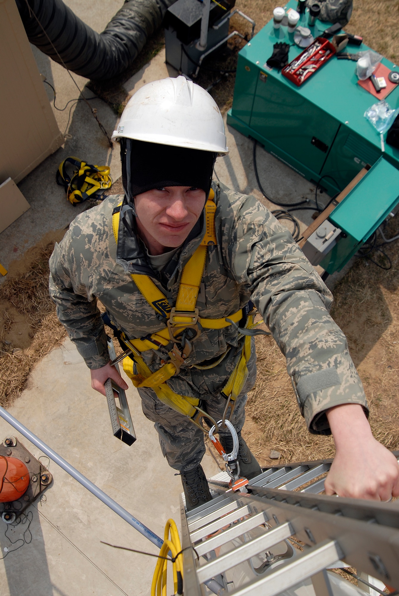 Staff Sgt. Steve Walker, an airfield systems journeyman with the 8th Communications Squadron, climbs down from a Glideslope Antenna Array after ensuring the antenna is level. Communication squadron Airmen installed the antennas at Kunsan Air Base, Republic of Korea, which will assist Wolf Pack pilots in landing at the base, even during inclement weather and low visibility. (U.S. Air Force Photo by SSgt Jason Colbert)