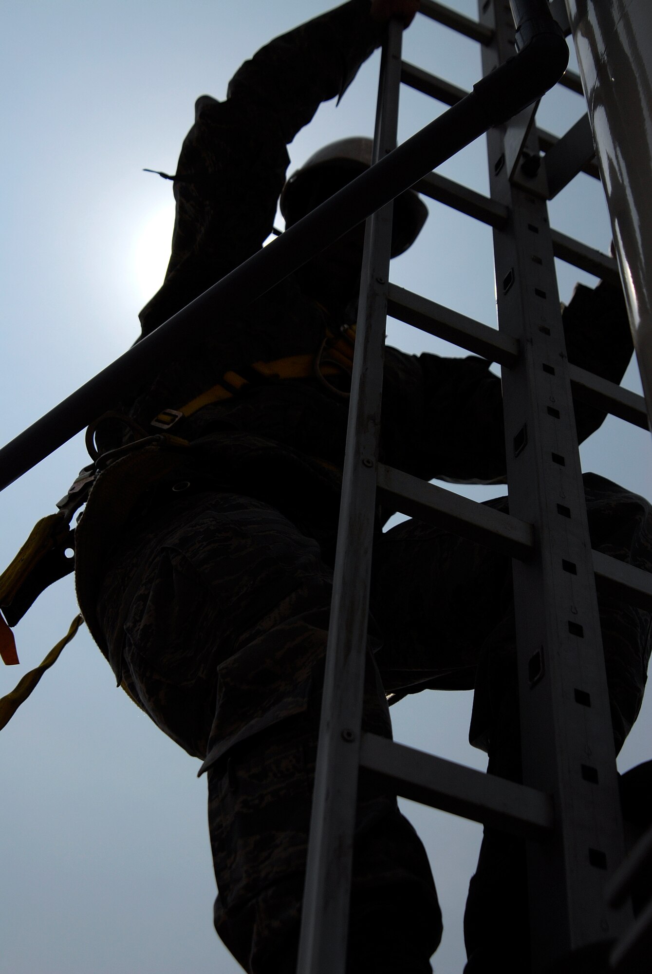 Staff Sgt. Steve Walker, an airfield systems journeyman with the 8th Communications Squadron, climbs down from a Glideslope Antenna Array after ensuring the antenna is level. Communications squadron Airmen installed the antennas at Kunsan Air Base, Republic of Korea, which will assist Wolf Pack pilots in landing at the base, even during inclement weather and low visibility. (U.S. Air Force Photo by SSgt Jason Colbert)

