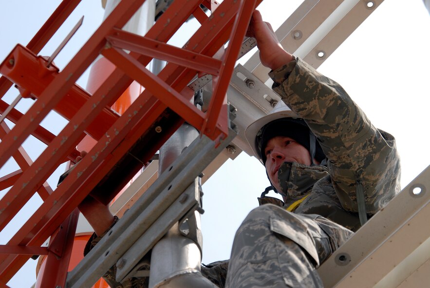Staff Sgt. Steve Walker, an airfield systems journeyman with the 8th Communications Squadron, makes sure that the Runway 1-8 Glideslope Antenna Array is level, April 4, 2009. Communications squadron Airmen installed the antennas at Kunsan Air Base, Republic of Korea, which will assist Wolf Pack pilots in landing at the base, even during inclement weather and low visibility. (U.S. Air Force Photo by SSgt Jason Colbert)

